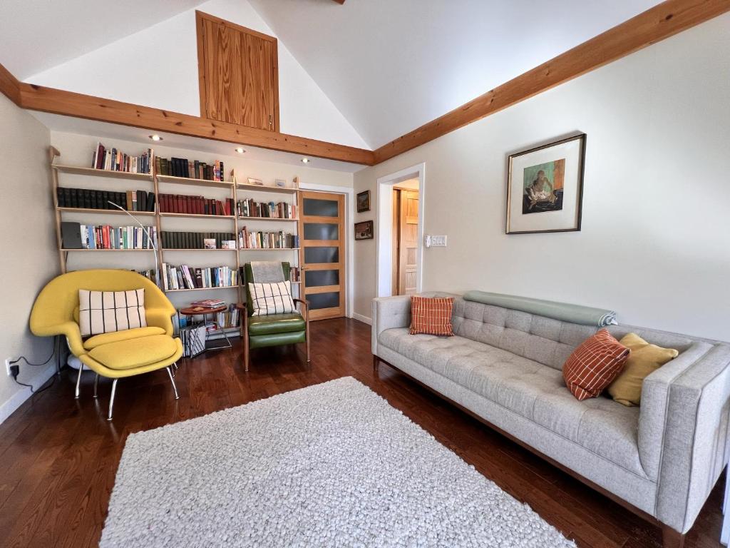 a living room with a couch and a chair at Cozy Creekside Retreat in Hillier