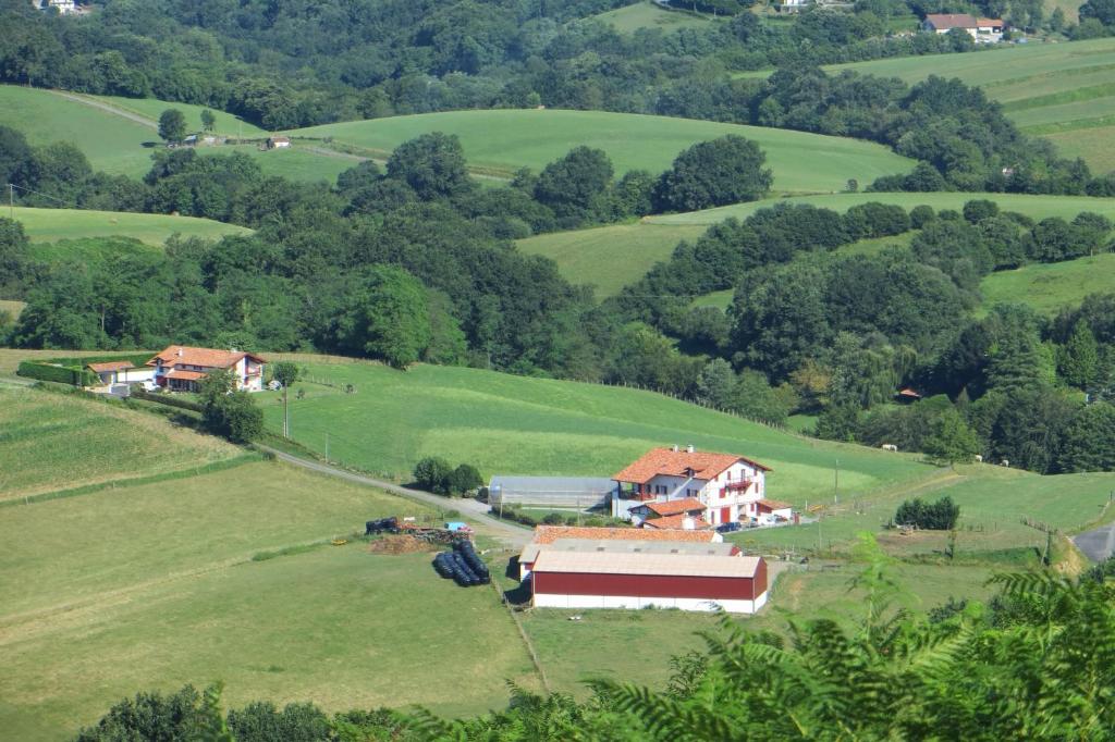 an aerial view of a house in a green field at Etxexuriko Borda in Aïnhoa