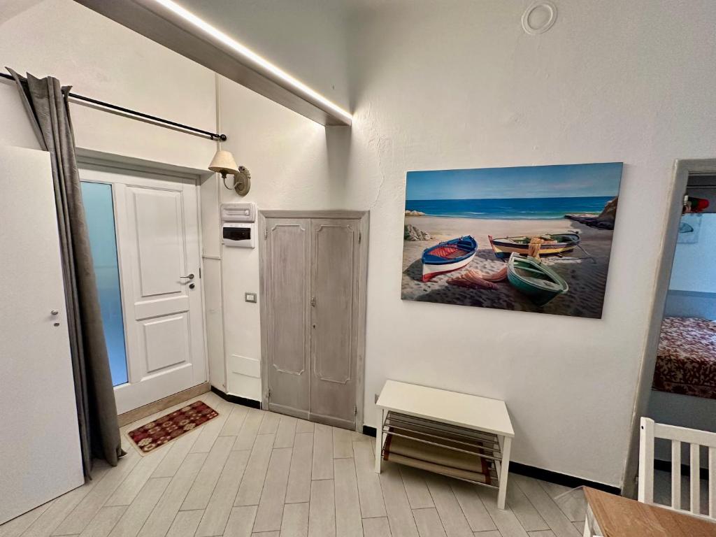 a room with a painting of boats on the wall at Via Del Santo - FrancamariaDotCom in Vernazza