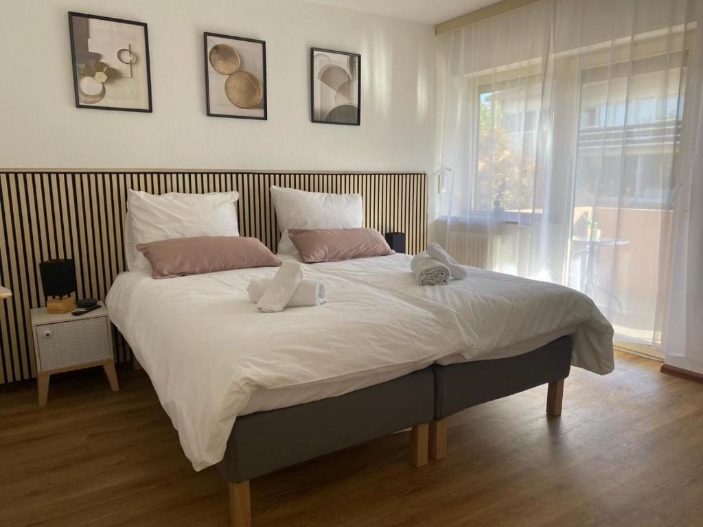 a bedroom with a large bed with two pillows at Appartement Au Rhin mit Balkon in Bad Bellingen in Bad Bellingen