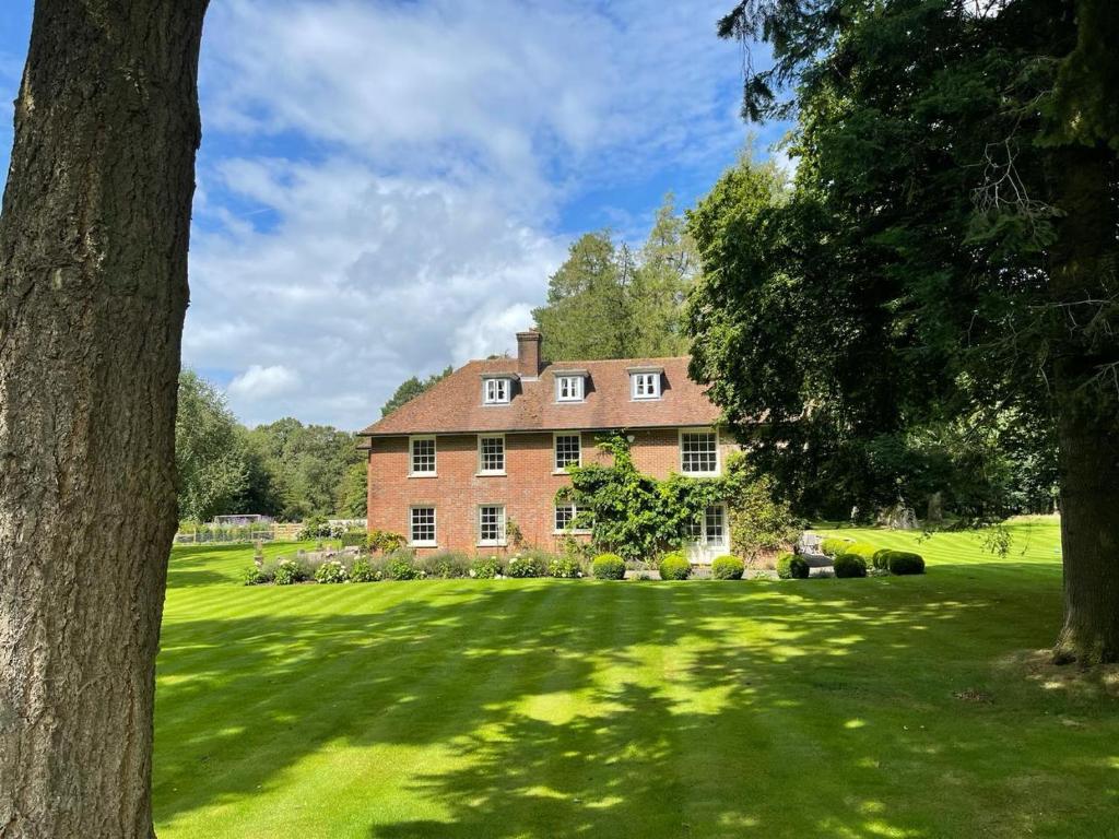 a large brick house on a green lawn at Isle Hill in Newbury