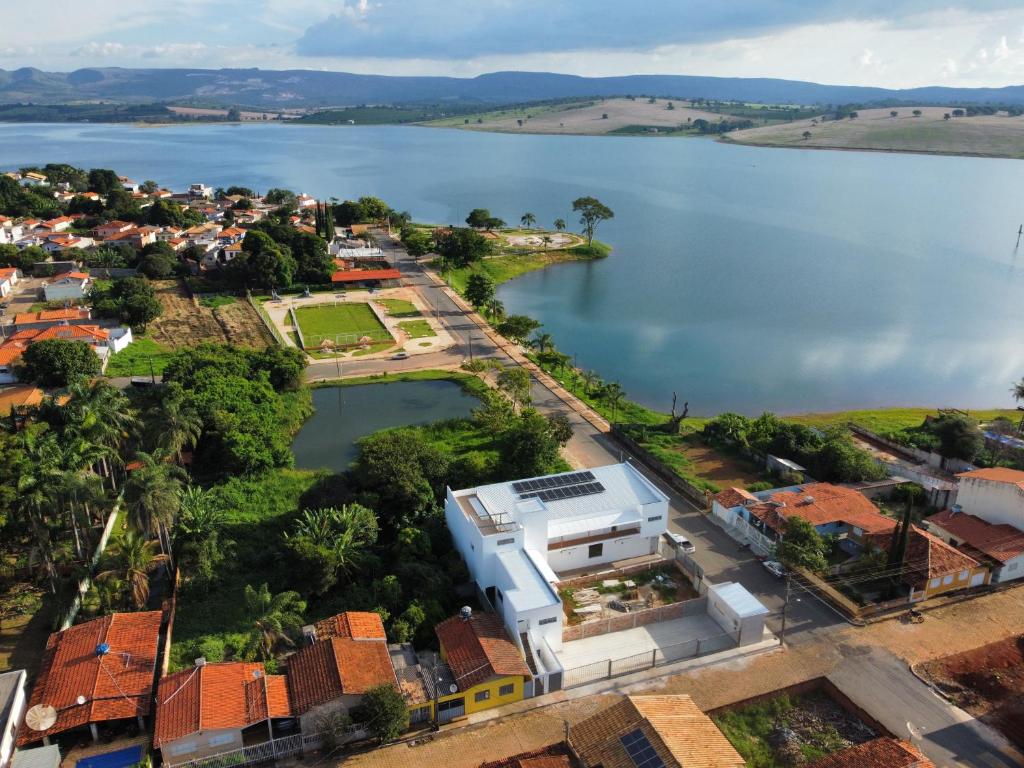 an aerial view of a house next to a lake at São Francisco Flats in Guapé