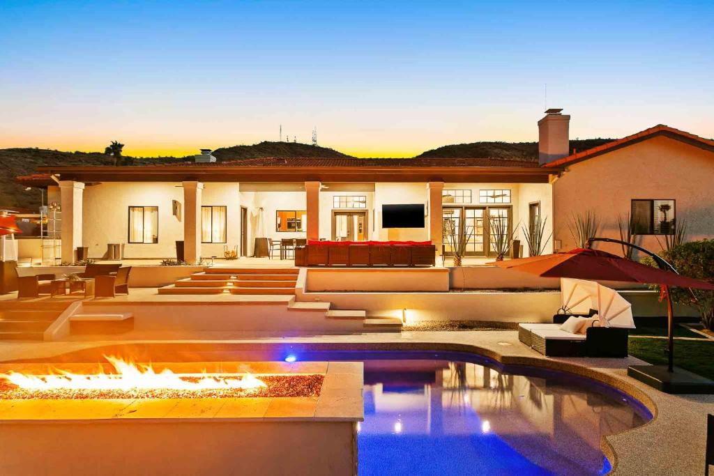 a house with a swimming pool with a fire pit at The Concept, A Vacation Retreat in Moon Valley in Phoenix