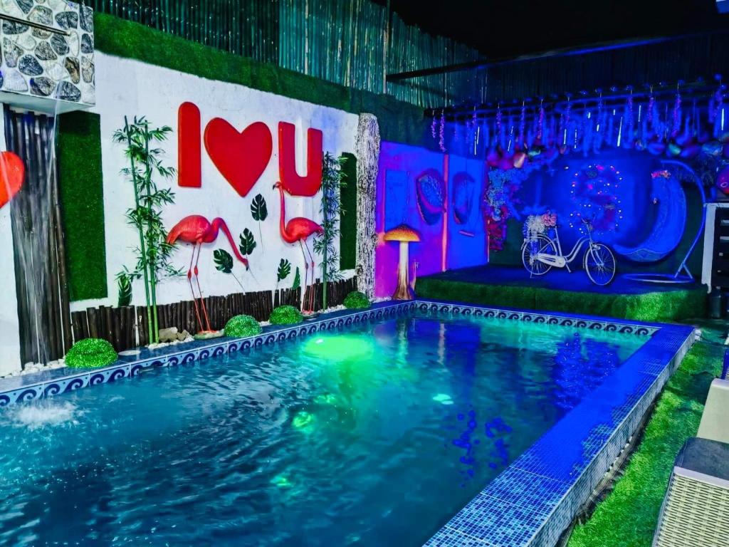 a swimming pool in a house with neon lights at Sharon’s Private Pool Villa in Mandaue City