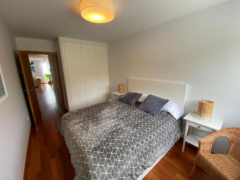 a bedroom with a bed with pillows on it at Apartamento av.Galicia playa in Finisterre