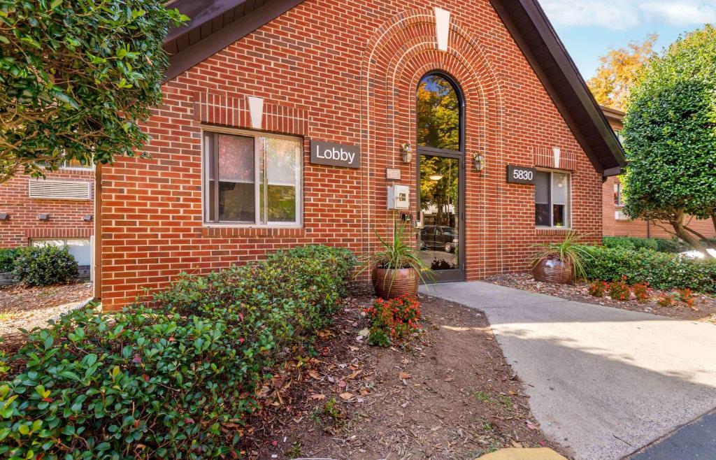 a brick building with a sign on the side of it at Extended Stay America Select Suites - Charlotte - Tyvola Rd - Executive Park in Charlotte