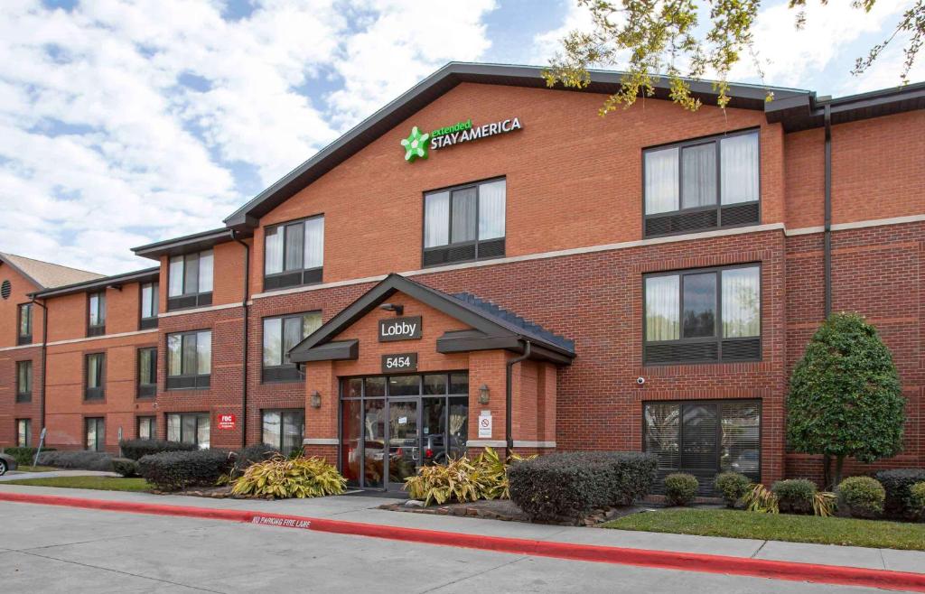 a large red brick building with a pharmacy at Extended Stay America Suites - Houston - Northwest - Hwy 290 - Hollister in Houston