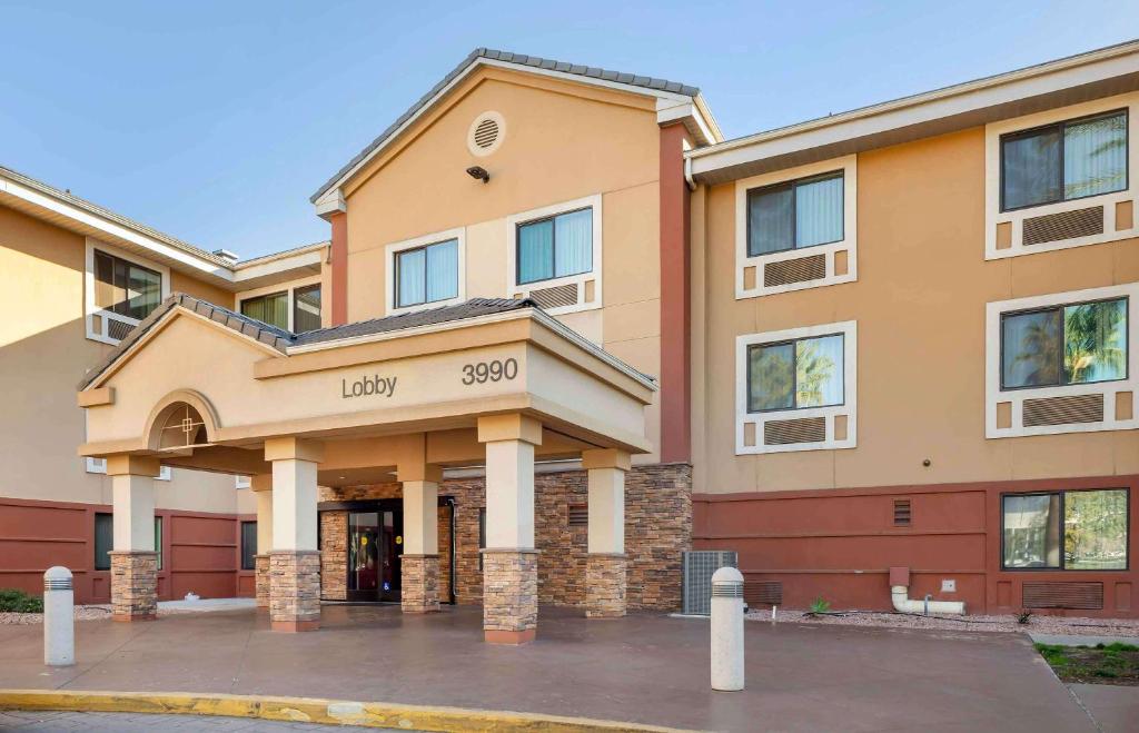 a large building with a sign that says lady at Extended Stay America Suites - Los Angeles - Ontario Airport in Guasti
