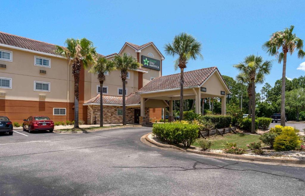 a hotel with palm trees and a parking lot at Extended Stay America Suites - Destin - US 98 - Emerald Coast Pkwy in Destin