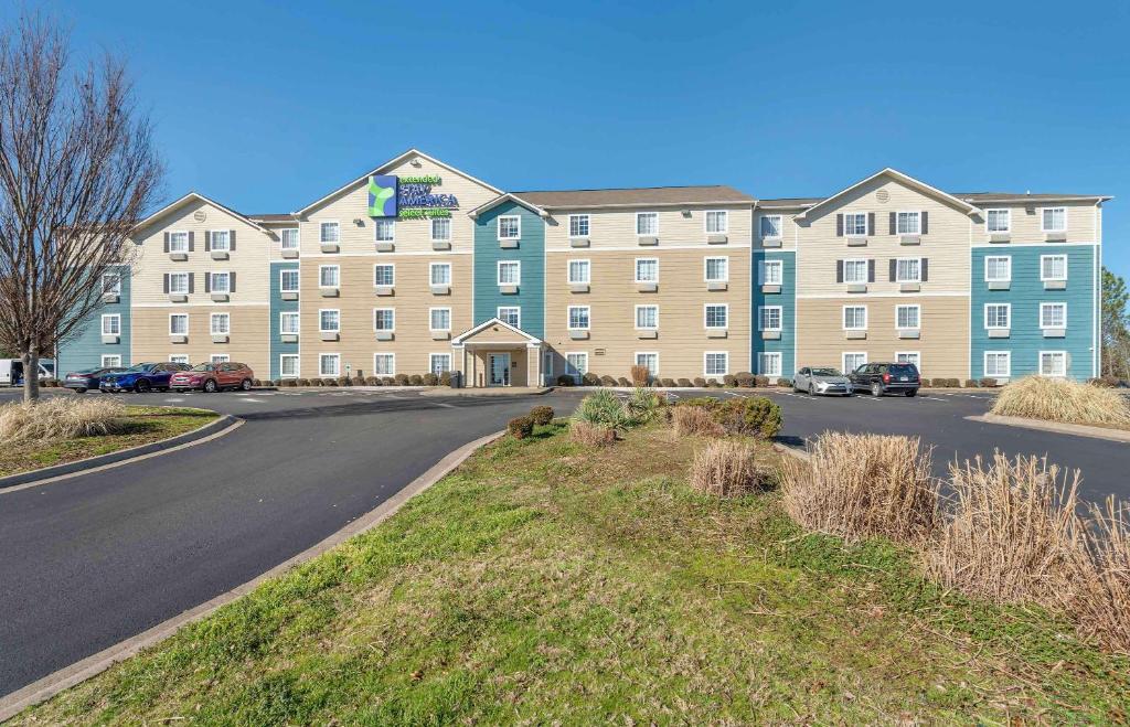 a large building with a road in front of it at Extended Stay America Select Suites - Little Rock - Southwest in Little Rock