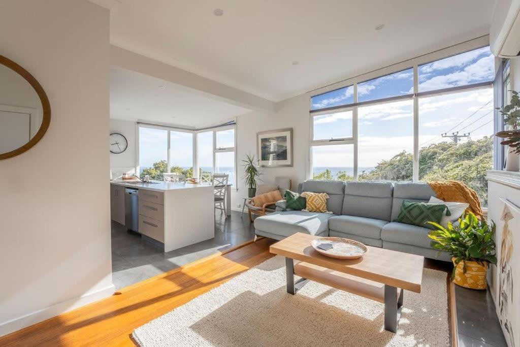 a living room with a couch and a table at Sea You Soon: Views Parking & WiFi in Burnie
