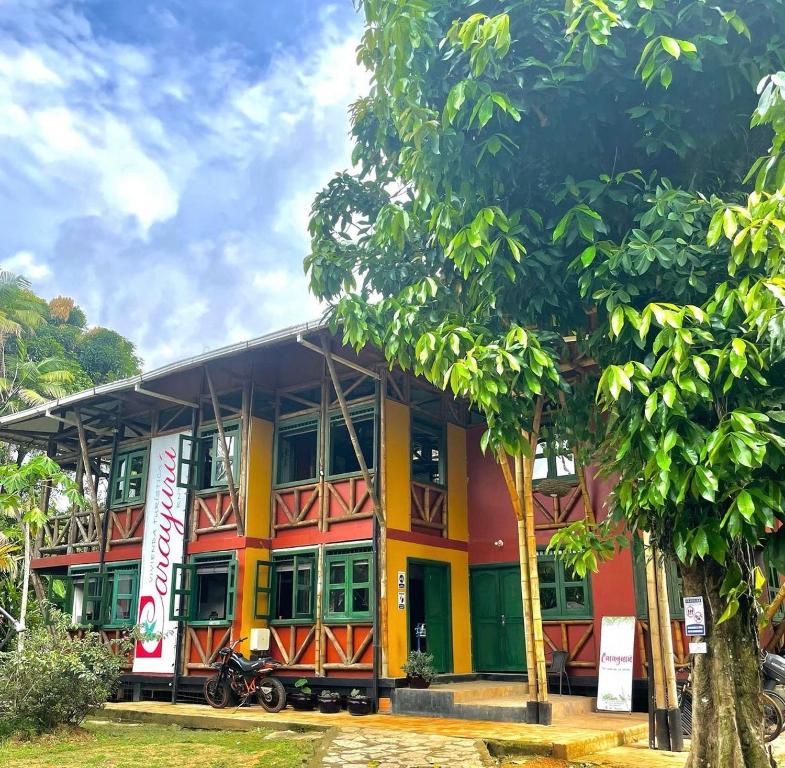 a colorful building with trees in front of it at Carayurú in Mitú