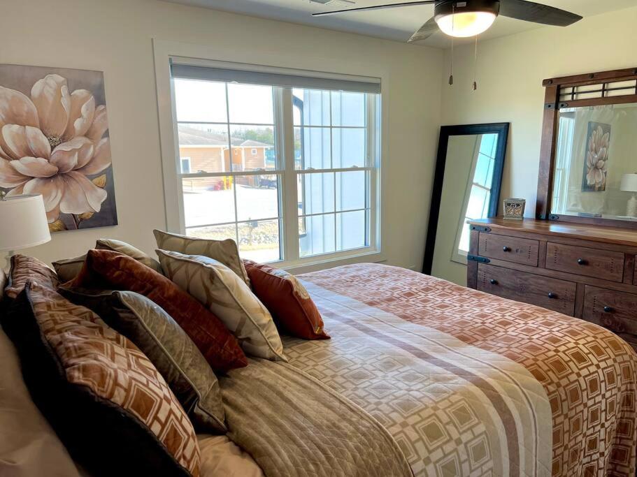 a bedroom with a large bed and a window at Fun House at SML Adventure filled Lake Retreat in Huddleston