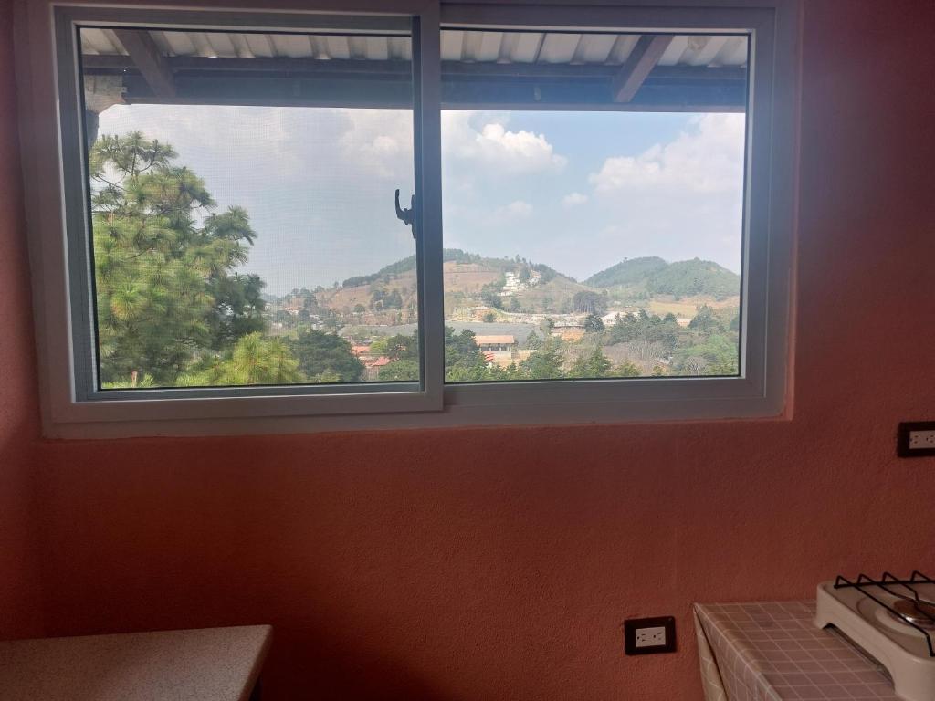 a window with a view of a mountain view at casamares - casanon in San José Pinula