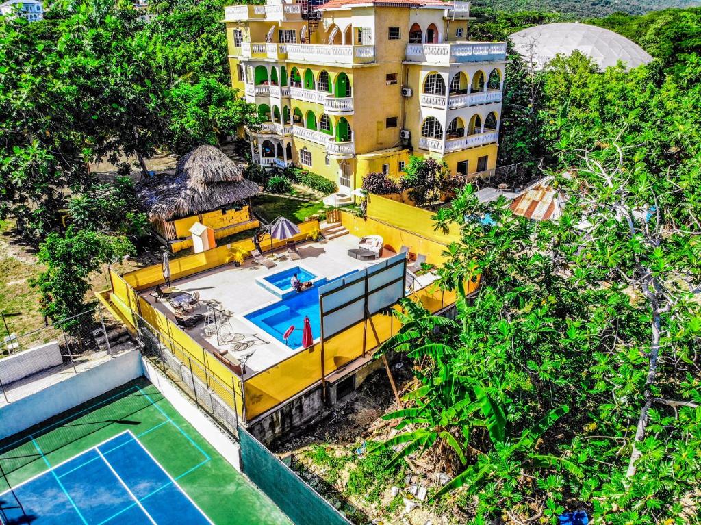 an aerial view of a house with a swimming pool at Takuma Boutque Hotel Hotel Rooms & Suites in Montego Bay