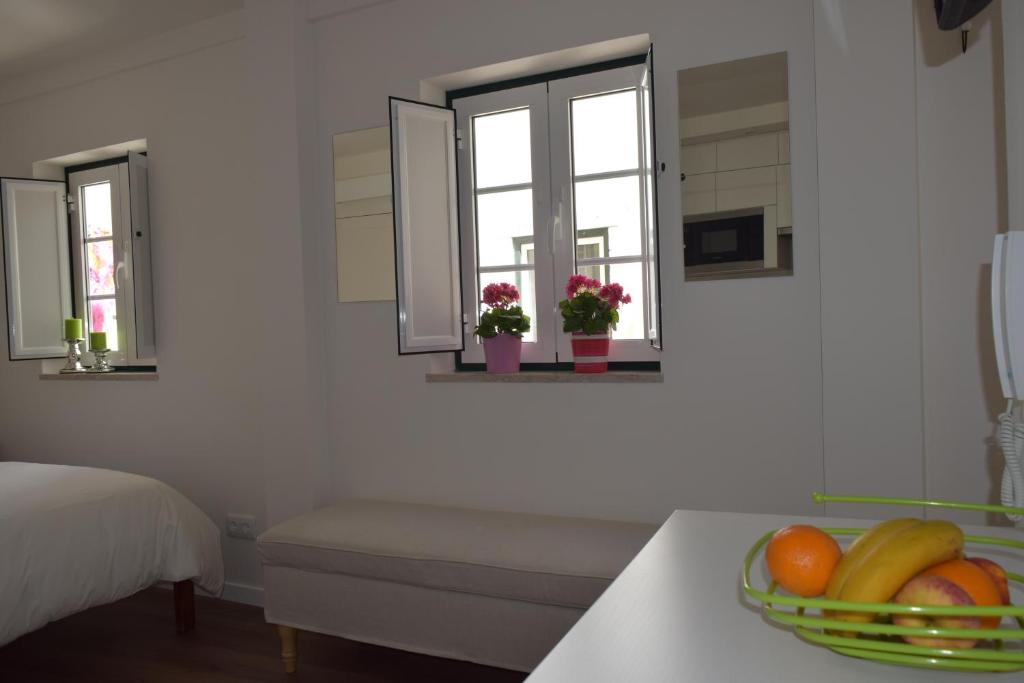 a kitchen with a bowl of fruit on a table at Acolhedor Apartamento Em Alfama in Lisbon