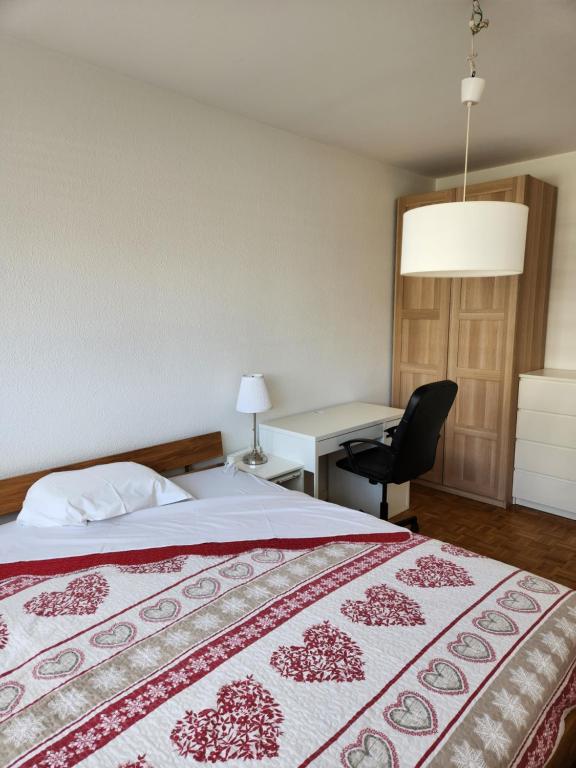a hotel room with a bed and a desk at Room in Shared Apartment Geneva in Geneva