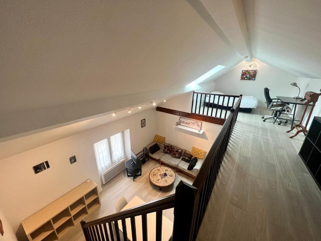 an overhead view of a living room with a staircase at Le 46 Magenta - Grand Duplex en hypercentre in Poitiers