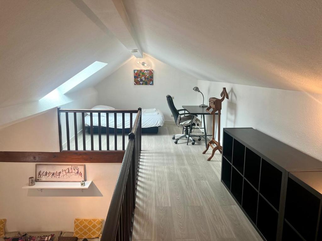 a attic room with a staircase leading to a bedroom at Le 46 Magenta - Grand Duplex en hypercentre in Poitiers