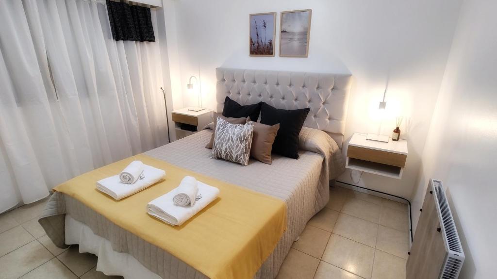 a bedroom with a bed with two pillows on it at Ainhoa Beach MDP - A Pasos del Mar in Mar del Plata