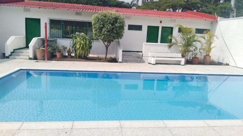 a blue swimming pool in front of a house at QUINTA MARIA LUISA in Melgar