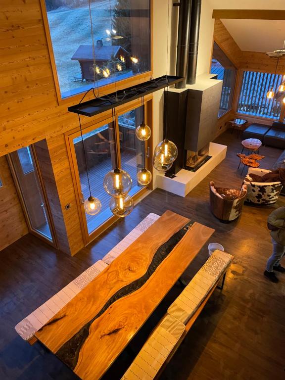 a living room with a wooden table and a large window at Chalet Cristal II in Les Contamines-Montjoie