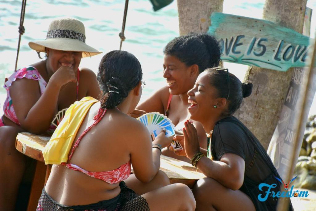 a group of women sitting at a table on the beach at Freedom Beach Club in Barú