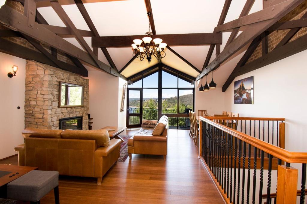 a living room with a vaulted ceiling with wooden beams at Heidelburg 3 of 6 Banjo Patterson Crescent in Jindabyne
