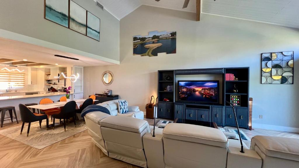 a living room with two couches and a tv at LuxeTPC Sawgrass - Immaculate Villa at the TPC in Ponte Vedra Beach