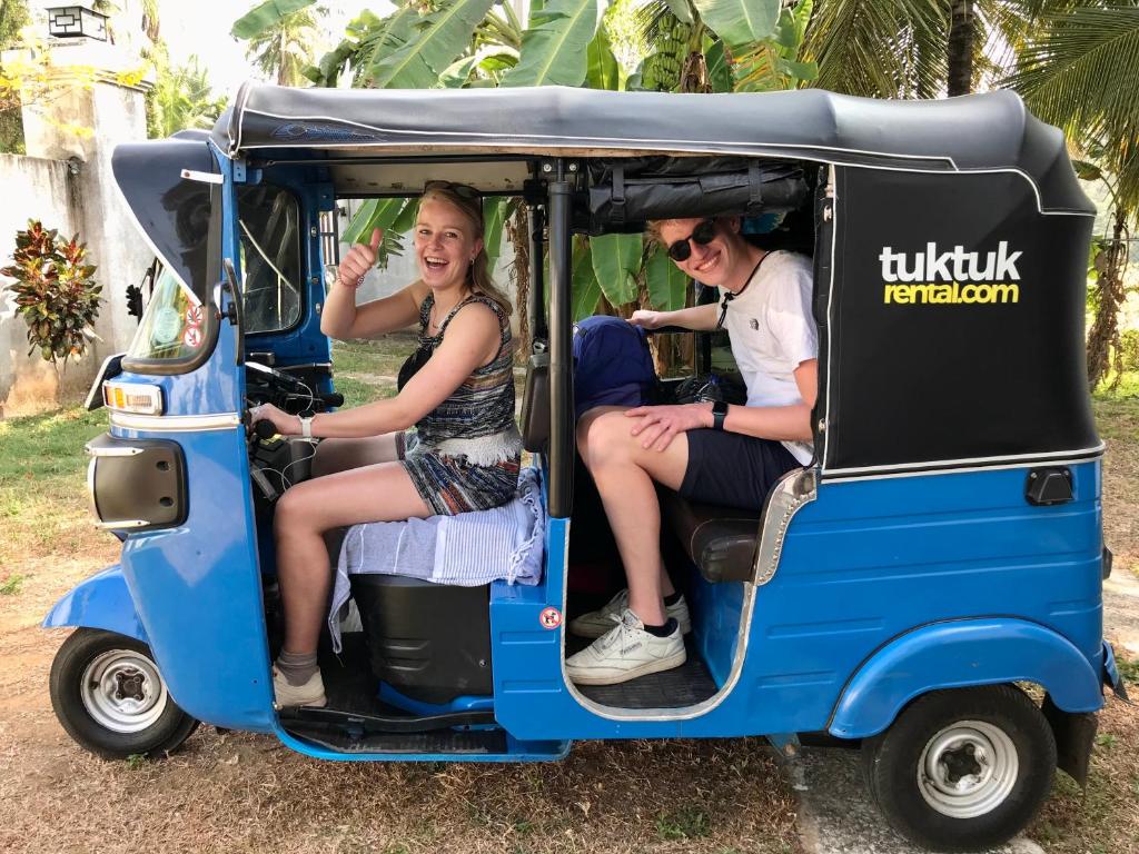 a group of people riding in a small vehicle at Lucky's Homestay in Maho