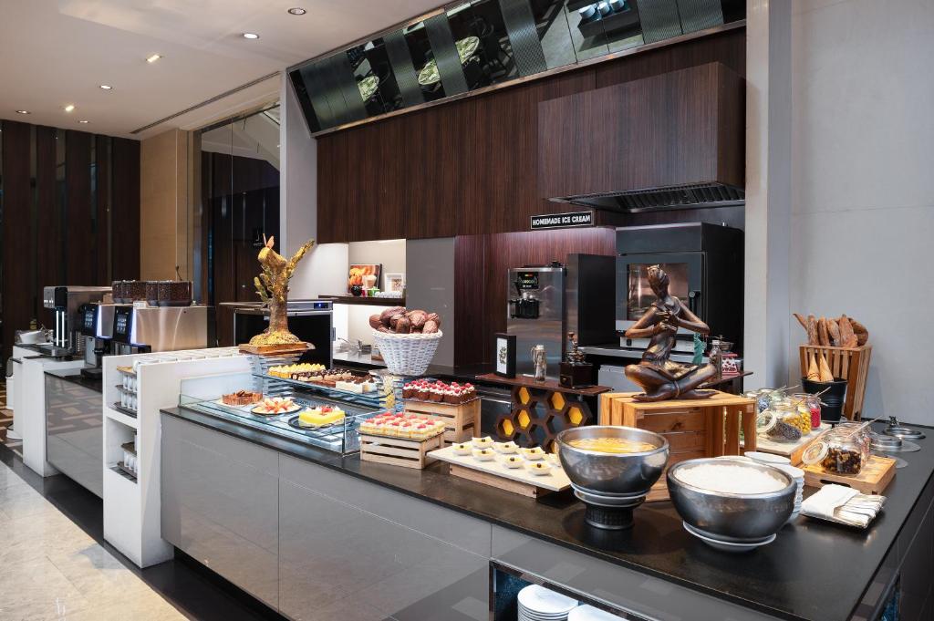 A bakery counter displaying pastries, desserts and coffee equipment.
