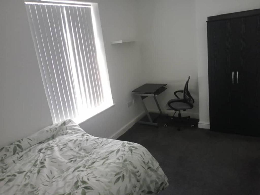 a bedroom with a bed and a desk and a window at Ensuite Double-bed (G3) close to Burnley city centre in Burnley