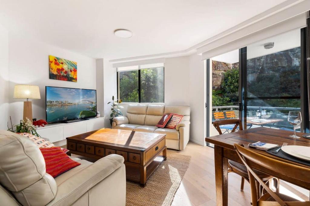 a living room with a couch and a table at Walking Distance to Darling Harbour in Sydney