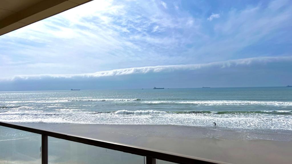 a view of the ocean from the balcony of a beach at Beautiful Beach Front Condo near Downtown in Rosarito