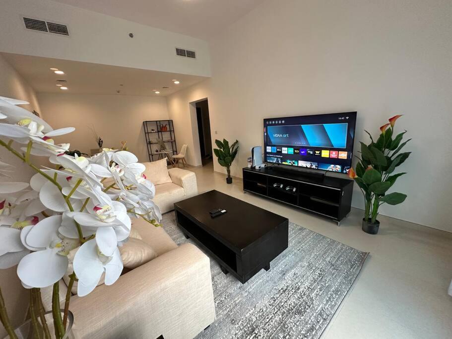 a living room with a couch and a flat screen tv at Luxurious spacious family home in Dubai