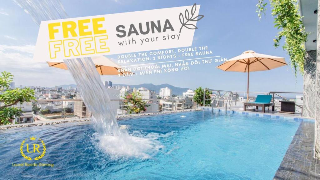 a pool with a water fountain on top of a building at Laurel Da Nang Apartment in Da Nang