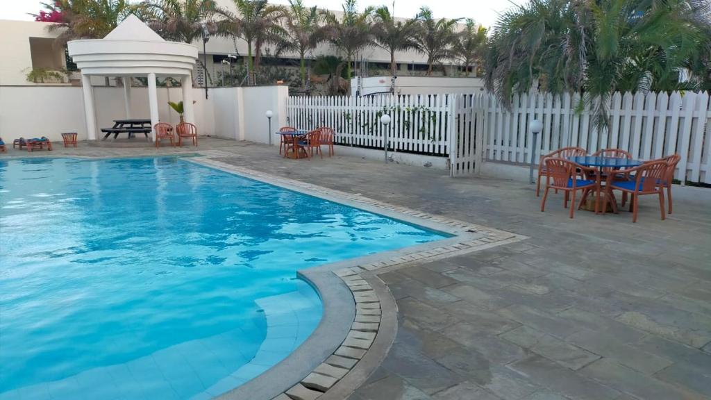 una grande piscina con tavolo e sedie di Ulah Properties a Mombasa