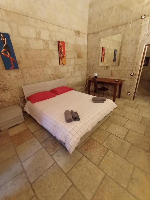 a bedroom with a bed with two slippers on it at Black Rose in Bari