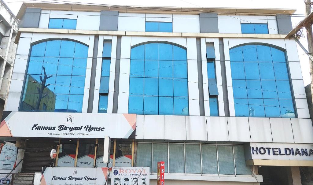 a large building with many windows on a street at Hotel Diana Gandhipuram in Coimbatore