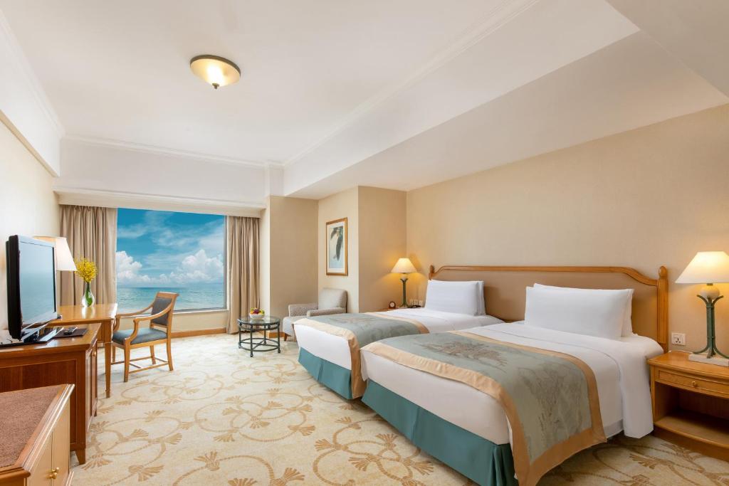 Postel nebo postele na pokoji v ubytování Shangri-La Beihai