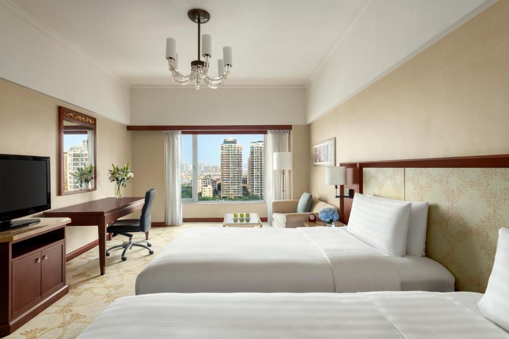 Postel nebo postele na pokoji v ubytování Shangri-La Beihai