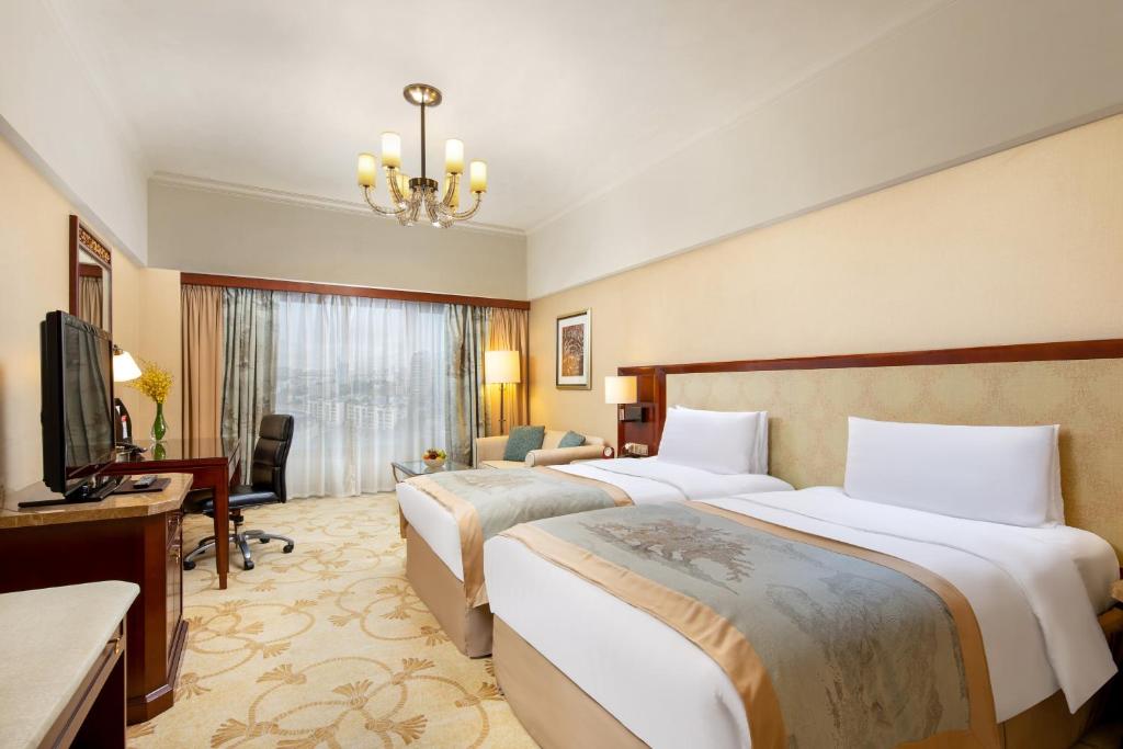 Postel nebo postele na pokoji v ubytování Shangri-La Beihai
