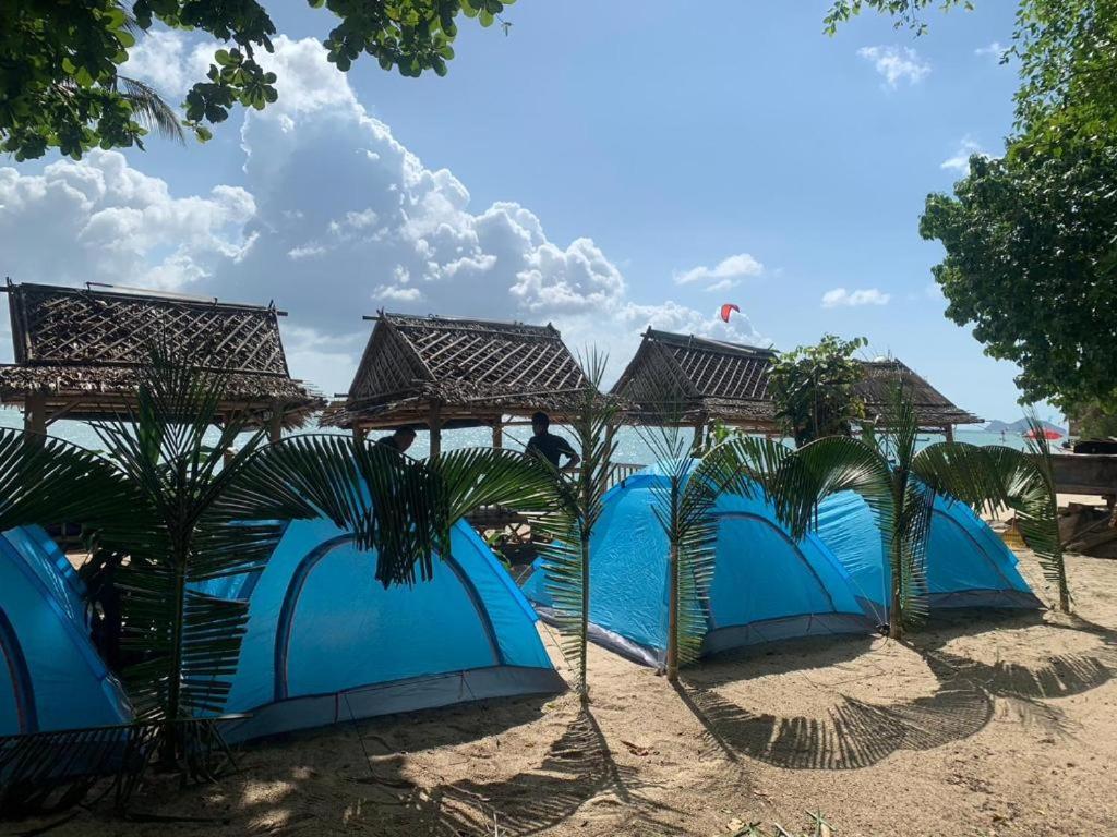 a group of blue tents on the beach at Two Rocks Bungalows in Ban Tai