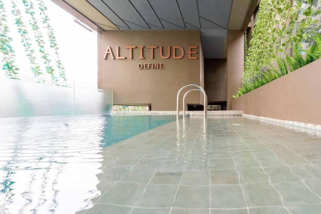 a swimming pool in the lobby of an office building at AL Define Condo in Bangkok