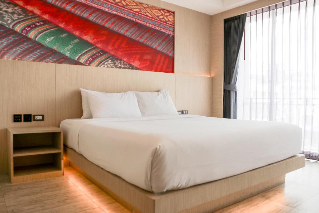 Postel nebo postele na pokoji v ubytování GLOW Pattaya