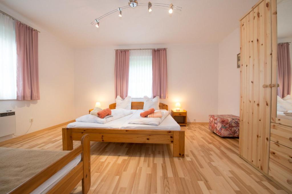 a large bedroom with a bed and a large window at Haus Göhringer / Ferienwohnungen in Hermagor