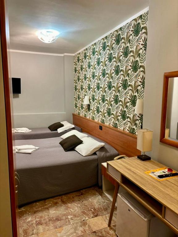 A bed or beds in a room at Hotel Delle Rose