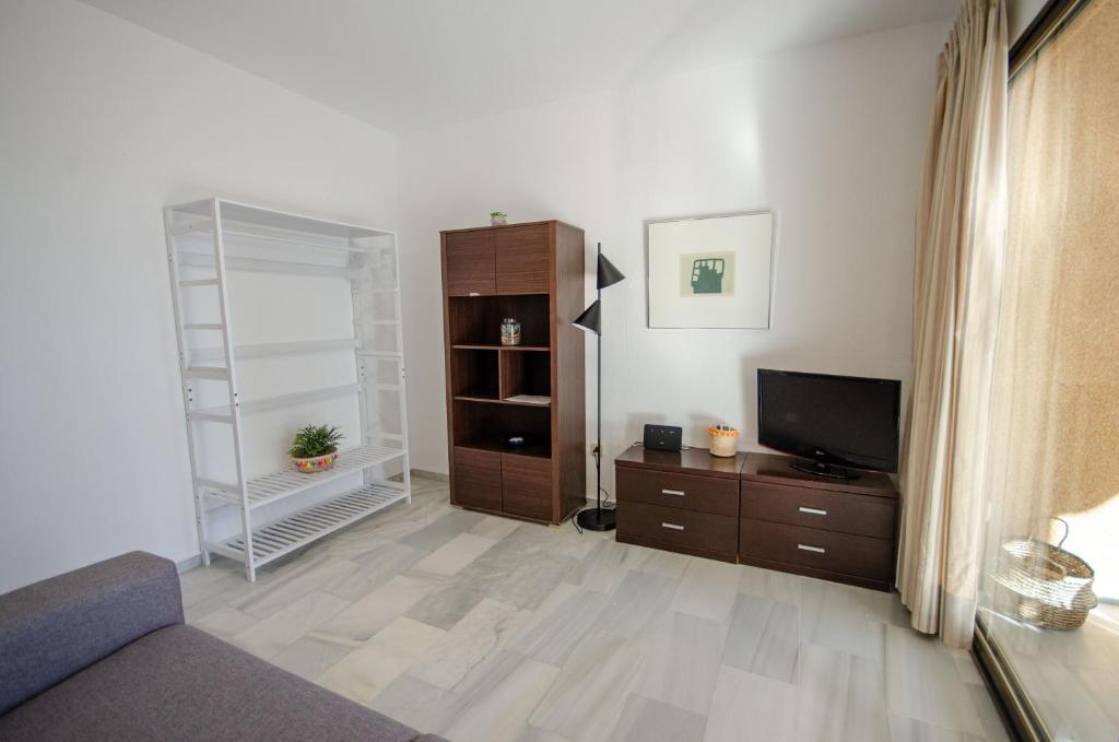 A television and/or entertainment centre at ARENA 8 Levante Beach