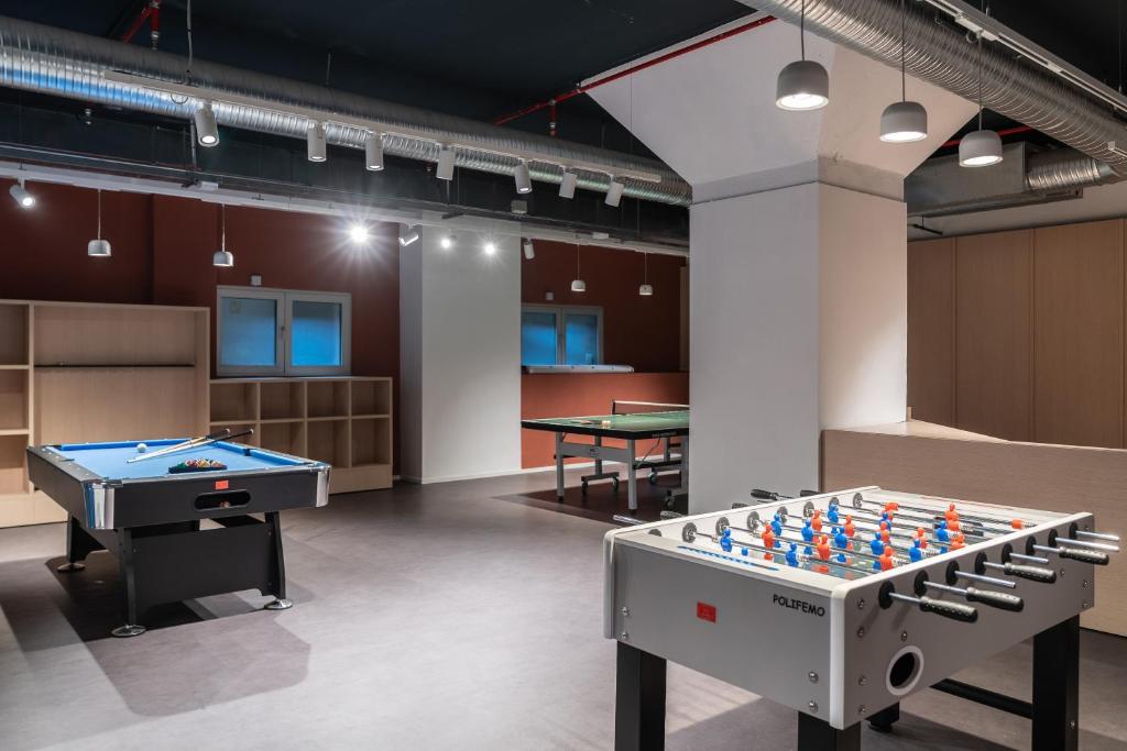 a large room with two pool tables and counters at aparto Milan Ripamonti in Milan