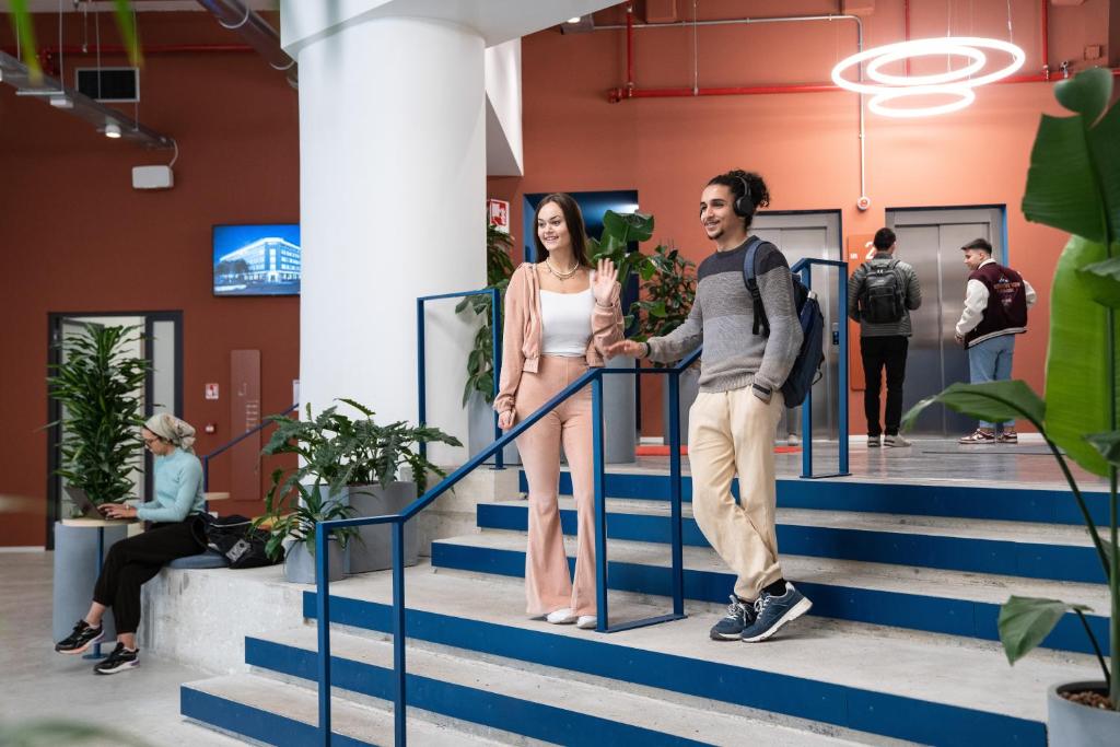 a man and woman standing on stairs in a building at aparto Milan Ripamonti in Milan